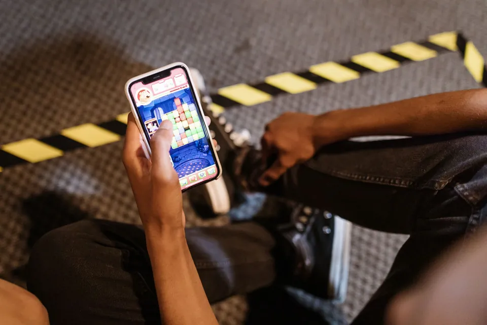 Person playing a mobile game on a smartphone, the kind of session where motion sensors and the touchscreen work together
