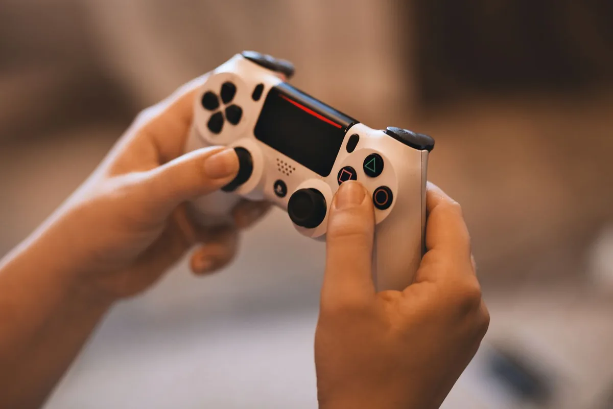 Hands tilting the analog stick of a white controller while checking how much dead zone masks drift