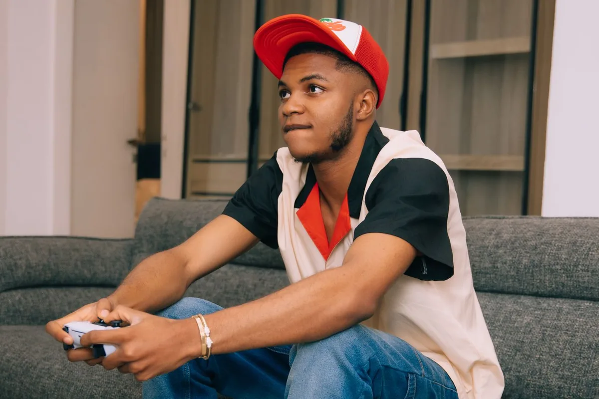 Gamer sitting on a couch playing with a controller, where per-game deadzone settings take effect