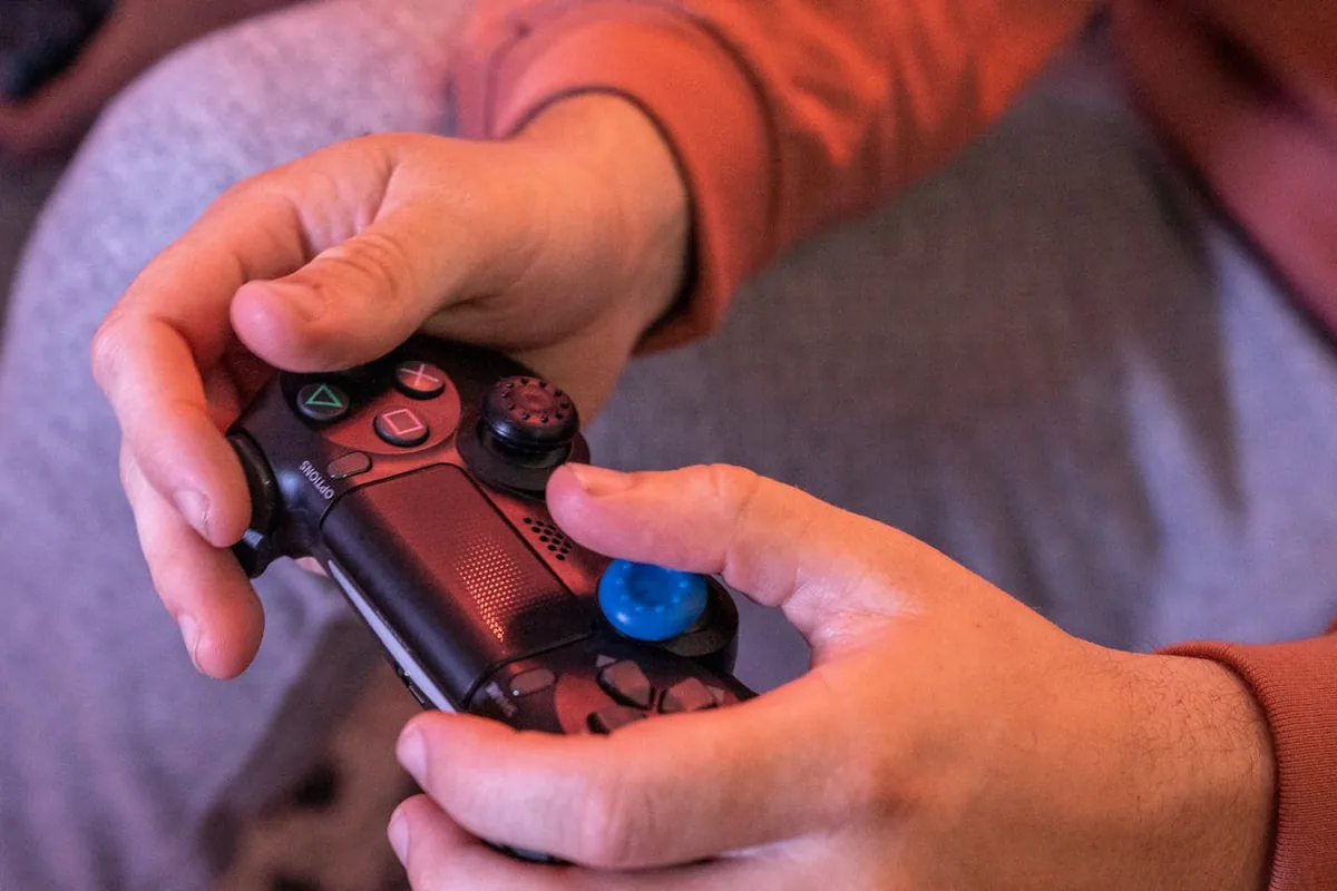Hands resting on a controller's analog sticks while running a stick drift test