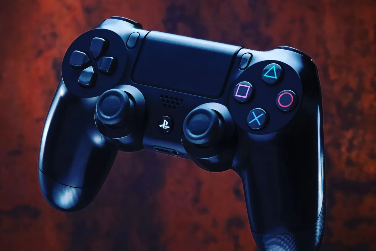 Dramatic close-up of a black PlayStation controller's analog sticks, illustrating what causes stick drift