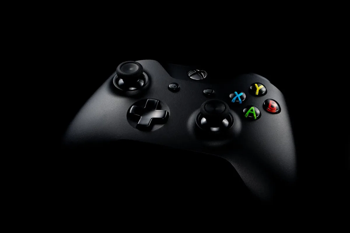 Black Xbox wireless controller on a dark background with the analog sticks in focus