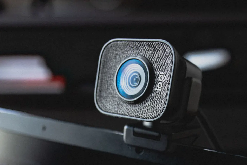 External webcam clipped to the top edge of a computer monitor, photographed close up
