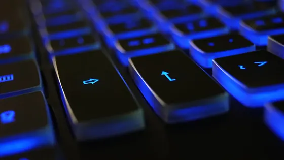 Close-up of a blue-backlit keyboard — what is keyboard ghosting and anti-ghosting explained