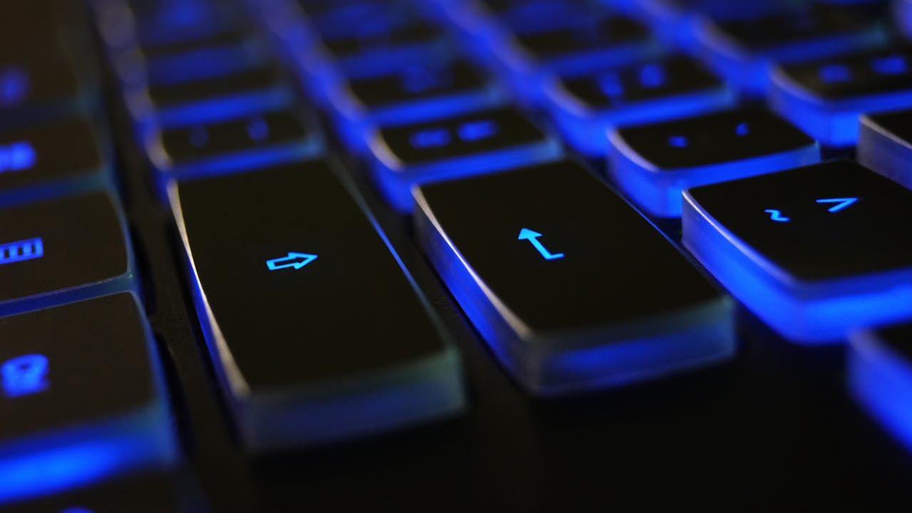 Close-up of a blue-backlit keyboard — what is keyboard ghosting and anti-ghosting explained