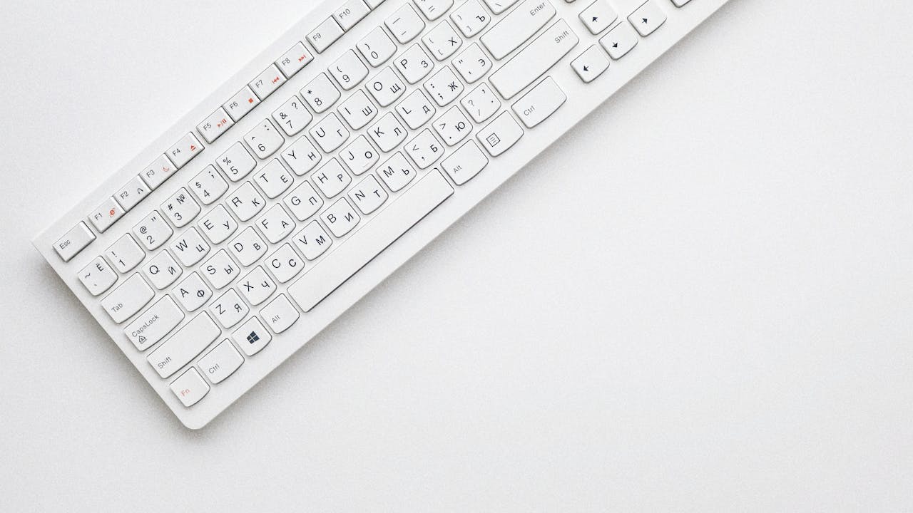 Top-down view of a compact wireless keyboard with all letter keys visible — used for testing ghosting and N-key rollover behaviour