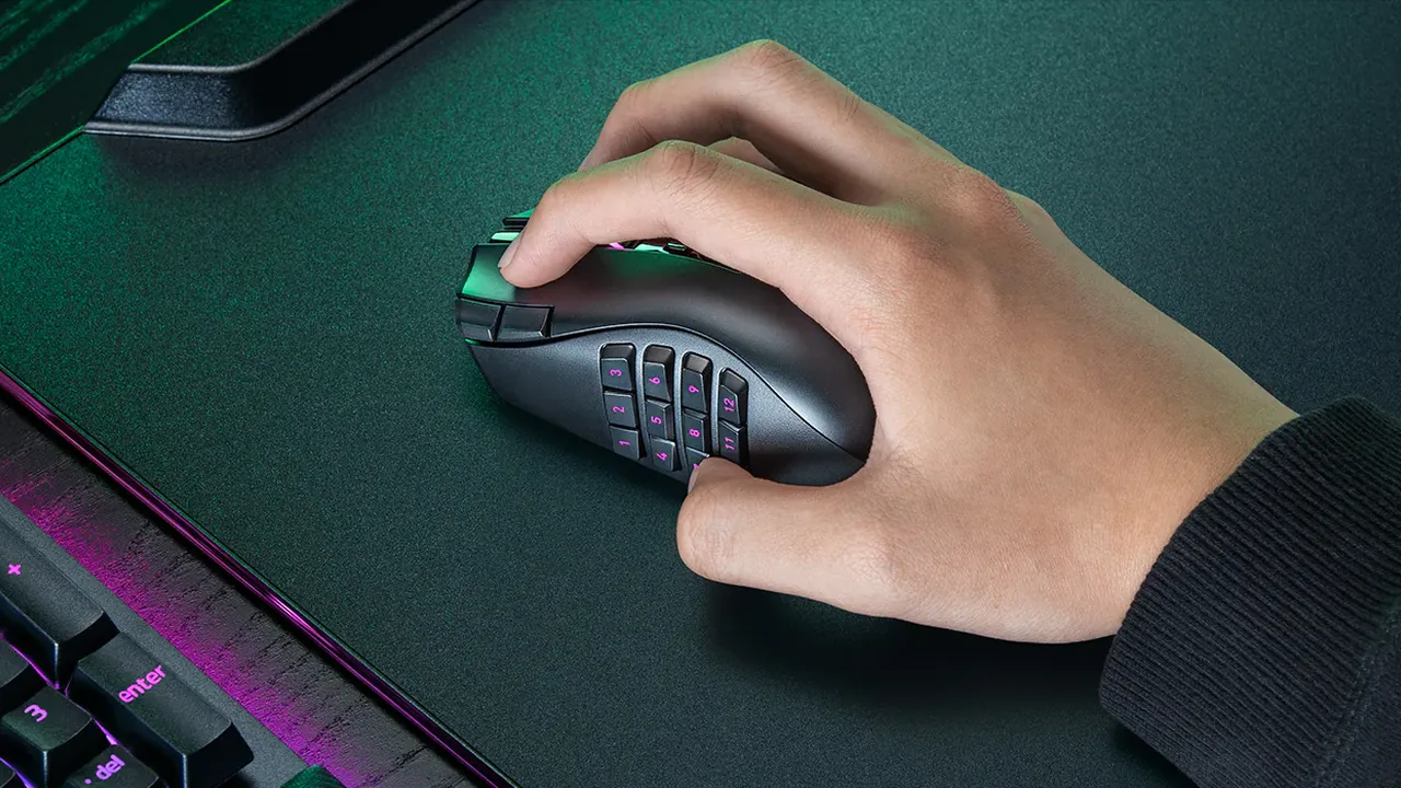 A gamer holding the black Razer Naga V3 Pro with its twelve-button side plate fitted