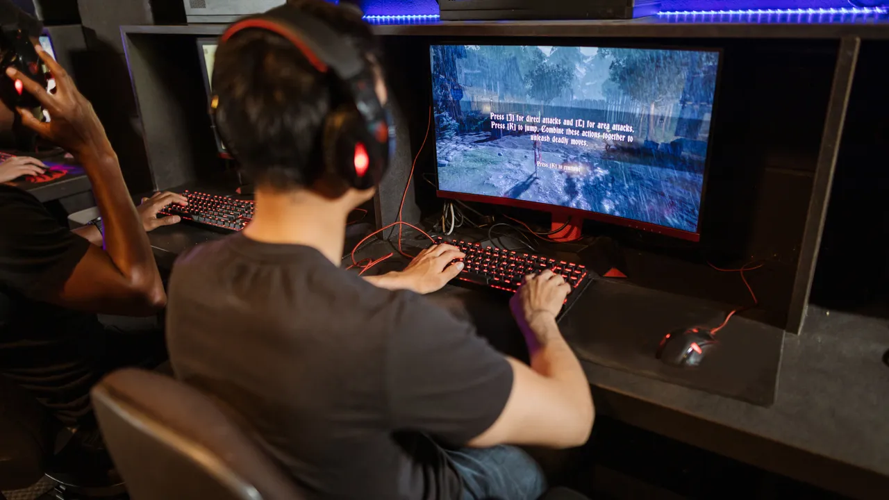 Focused gamer at a desk during an aim trainer session, checking whether their mouse accuracy score is good