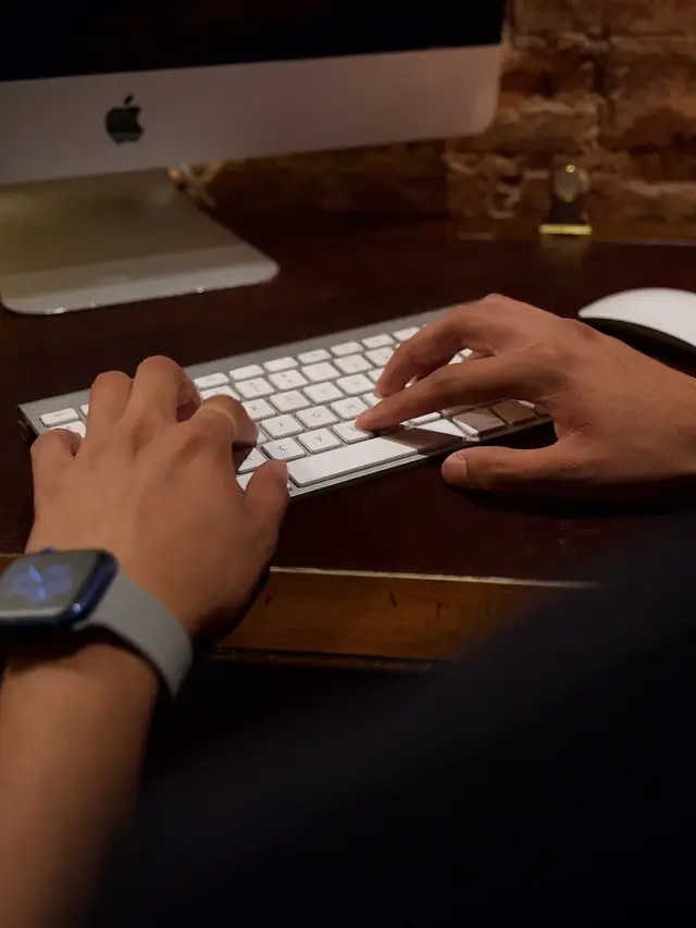 Person deliberately touching a key on a desktop keyboard