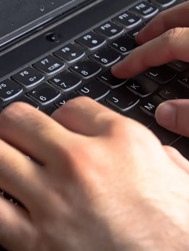Close view of a finger pressing and releasing a keyboard key