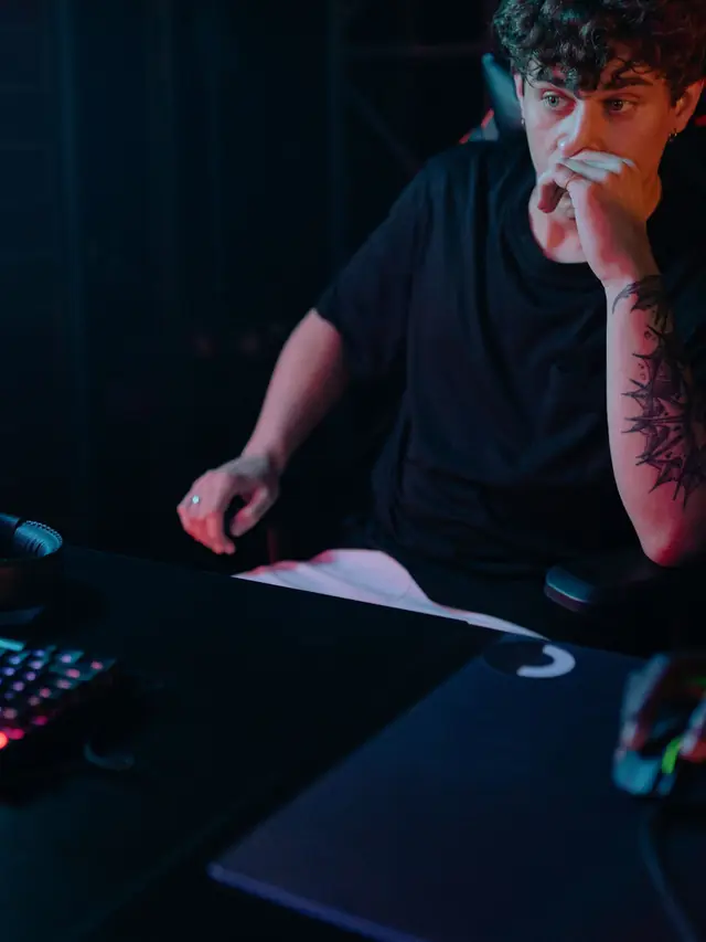 The recurring curly-haired gamer looking thoughtfully at a computer screen; stock illustration of comparing sizes