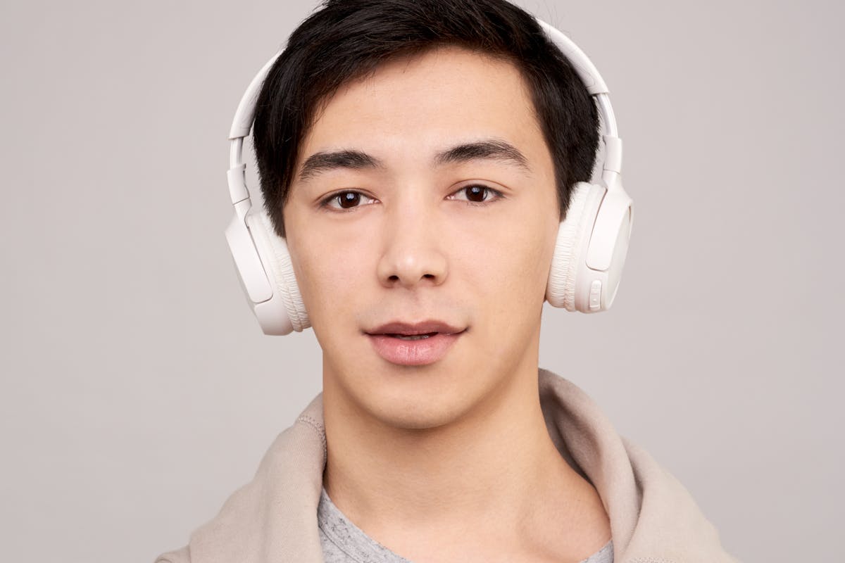 Hearing age test - young person in headphones taking a high-frequency mosquito tone hearing test